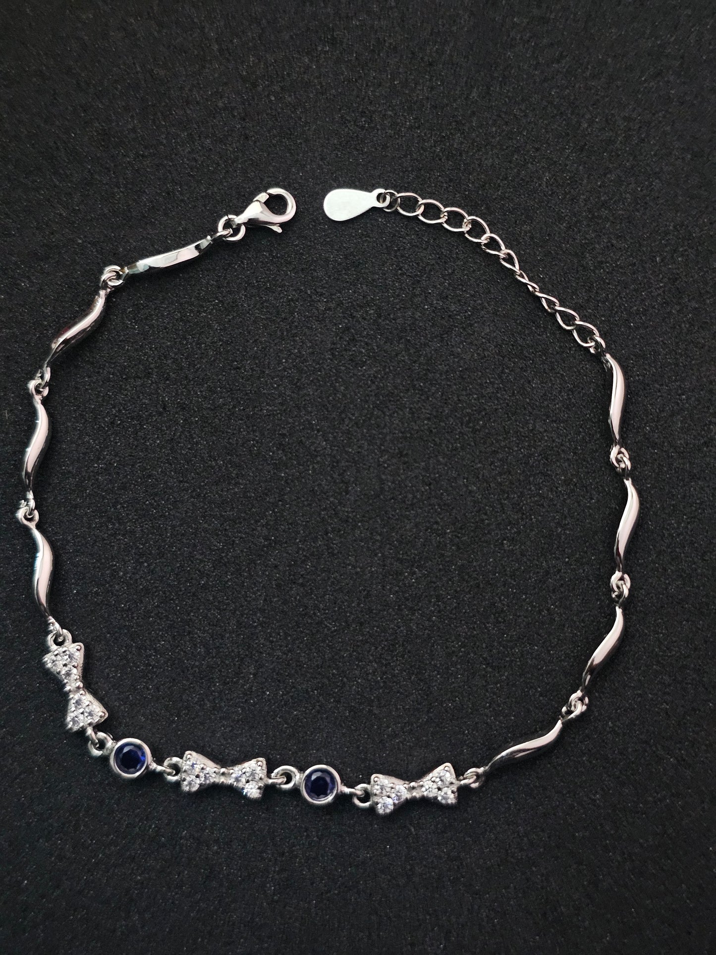 Sparkling Silver Bracelet with Bow Motifs & Blue Accents