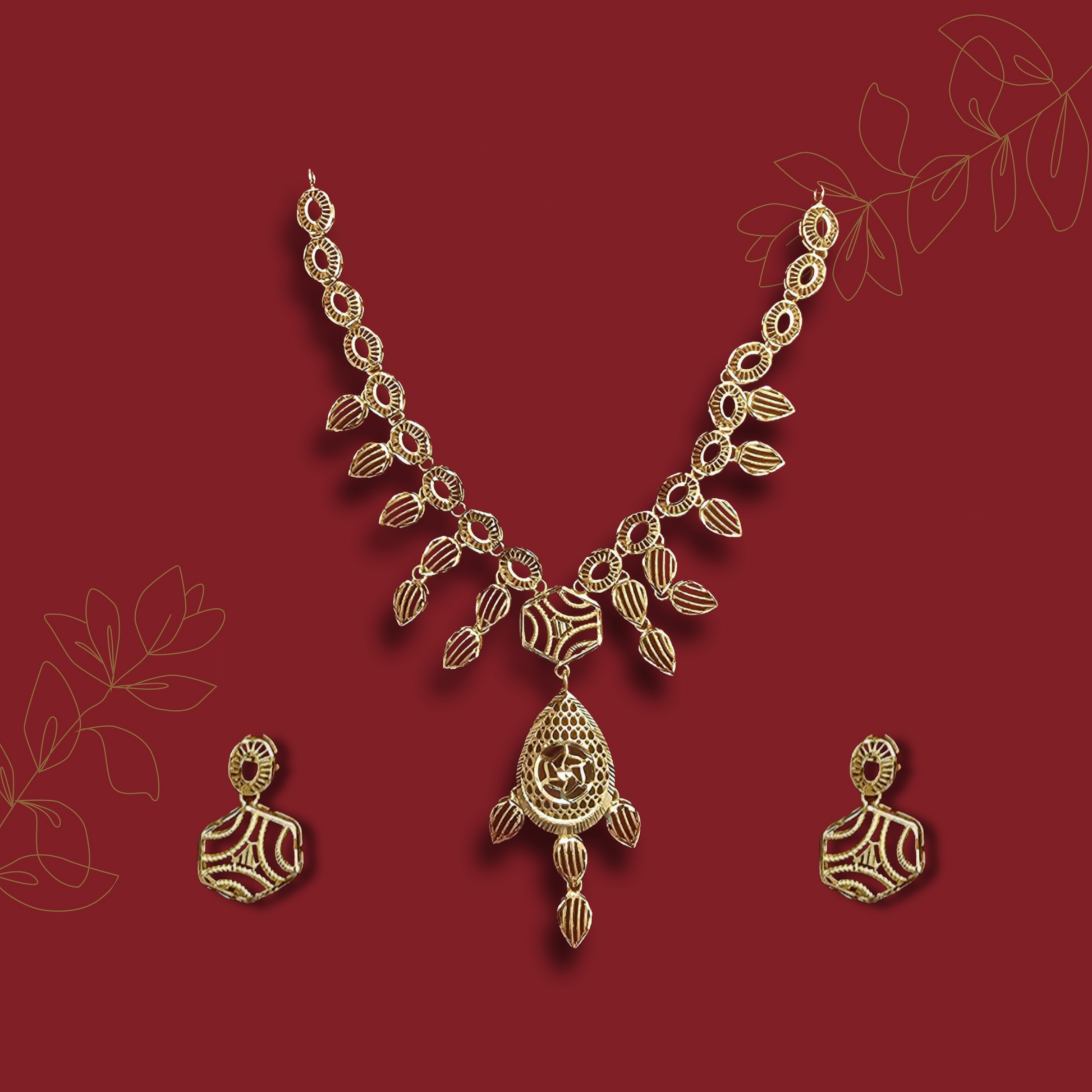 Gold necklace and earrings on a red background with leaf designs.