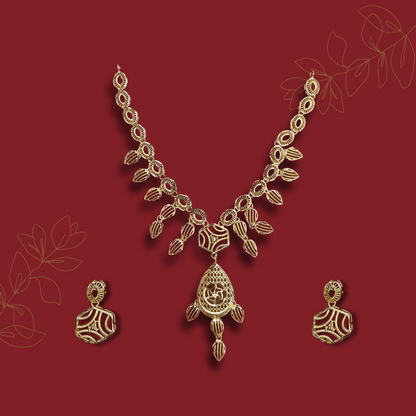 Gold necklace and earrings on a red background with leaf designs.